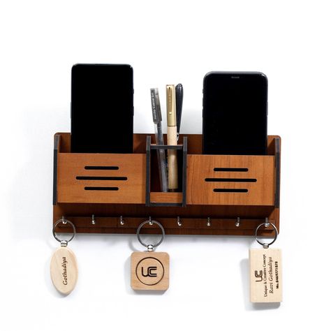 This beautiful, handmade key hanger is made of solid wood and features a unique mobile stand that allows you to easily access your keys. It's the perfect way to keep your keys organized and within reach, and it makes a great gift for anyone who loves unique home.#laserkeyholder #keyorganization #customkeyholder #keyaccessories #keyholderdesign Mobile Stand Wooden, Key Stand, Wall Decora, Wooden Mobile, Hotel School, Wooden Key Holder, Pen Stand, Laminated Mdf, Mobile Stand