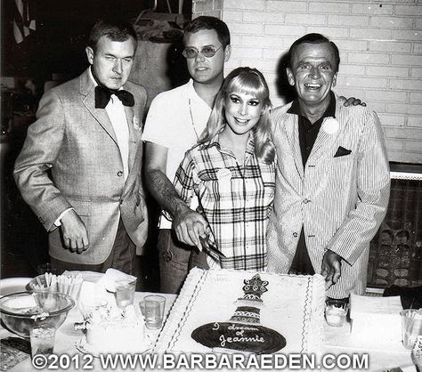 "I Dream of Jeannie" cast members (left to right) Bill Daily, Larry Hagman, Barbara Eden and Hayden Rorke celebrate the 100th Episode of I DREAM OF JEANNIE. This shot was taken on the set; you may notice the fireplace of the Nelson living room behind them. You may also notice the sound stage behind them on the left hand side of the photo. Barbra Eden, Twilight Cake, Larry Hagman, Barbara Eden, I Dream Of Jeannie, Dream Of Jeannie, Classic Television, Old Tv Shows, Vintage Tv