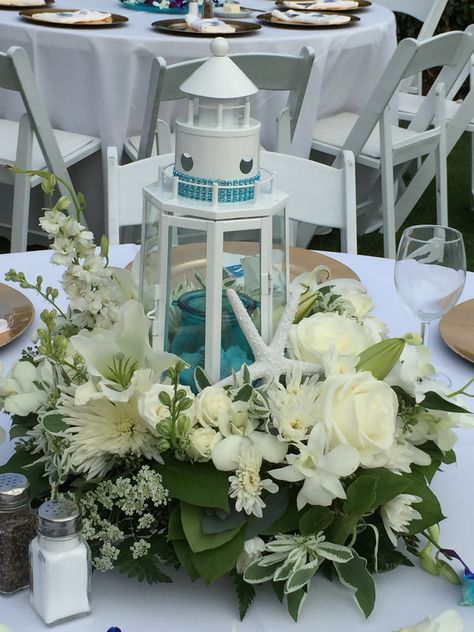 Lighthouse Lantern Centerpiece, Lighthouse Wedding Centerpieces, Diy Nautical Centerpieces, Lighthouse Floral Arrangements, Wedding Centerpieces Nautical, Lighthouse Theme Wedding, Beach Lantern Centerpieces, Nautical Centerpiece Ideas Wedding, Lighthouse Centerpiece Wedding