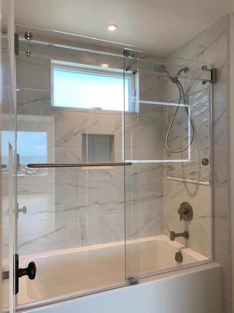 Eliminate as much metal as possible with the Titan Phantom, All-Glass Header, Barn Door Style Shower/Tub Enclosure. Shower Door For Tub, Shower Barn Door, Lake Bathroom, Tub Enclosures, Guest Bathroom Remodel, Frameless Sliding Shower Doors, Full Bathroom Remodel, Bathroom Remodel Shower, Sliding Shower Door