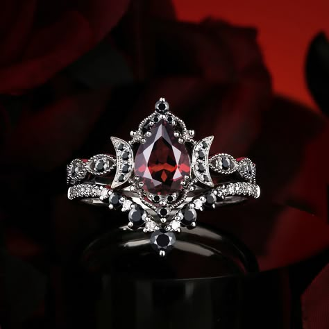 The striking contrast of red and black in ring design evokes an intense, dramatic elegance, merging passion and mystery into a bold statement of timeless beauty. Follow @starlandusjewelry for more nontraditional jewelry/alternative engagement rings! #ringselfie #ringlover #engagementring #jewelrybrand #jewelry #moissanitering #weddinginspo #diamond #moissaniteweddingring #jewelrydesigner #engagementringsforwomen #nontraditional #alternativebride #garnet #garnetring #garnetjewelry #foryoupag... Dark Fantasy Engagement Ring, Gothic Rings Engagement, Dark Engagement Ring, Fantasy Engagement Rings, Goth Engagement Rings, Jewelry Alternative, Nontraditional Engagement Rings, Gothic Wedding Rings, Gothic Engagement Ring