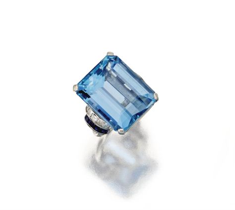 AQUAMARINE, SAPPHIRE AND DIAMOND RING, CIRCA 1945. The emerald-cut aquamarine weighing approximately 32.00 carats, flanked by arcs of square-cut diamonds weighing approximately 1.00 carat, further set with calibré-cut sapphires, mounted in platinum Sapphire And Diamond Ring, Aqua Marine, Square Cut, Van Cleef, High Jewelry, White Metal, Emerald Cut, Tiffany & Co., Lalique