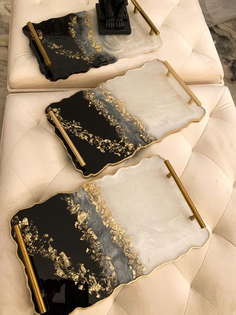 A large size handmade resin tray , made with pearl white, black and a stunning touch of gold and finished with brass gold handles . Perfect gift for Christmas or any occasion, and a stunning piece to decorate any room in the house ! Its 24X12x1 inches ( message me for a different colors or shape or size ) the tray surface is not slippery and hold up to 120f ( easy to wash with soap and water ) Epoxy Resin is UV sensitive, appropriate UV blockers are used in the formula but may yellow over time w Black And Gold Resin Tray, Black And White Resin Tray, Resin Tray Ideas, Black White And Gold Christmas, Resin Art Tray, Senior Table, Epoxy Tray, Diy Resin Gifts, Resin Serving Tray