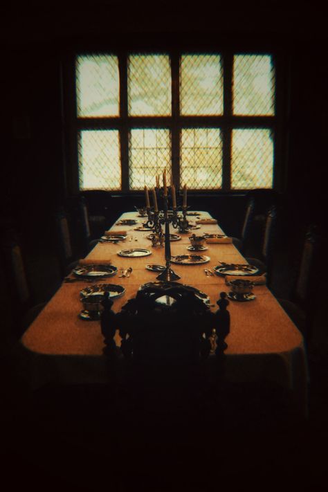 dark academia picture in a castle Hannibal Dinner Table, Dark Academia Dinner Table, Dinner Table Aesthetic Dark, Royal Dinner Table Aesthetic, Creepy Dining Room, Mystery Movie Aesthetic, Dinner Table Reference, Dark Dinner Table Aesthetic, Clue Movie Aesthetic