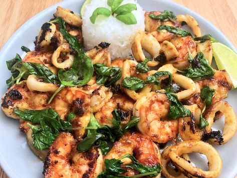 Asian-Glazed Shrimp and Calamari with Wilted Basil is a recipe that has big yet subtle flavors happening simultaneously. It’s sweet and spicy (but not too spicy!) with the perfect amount of umami-ness from the fish sauce to bring it all home. This is such a simple recipe to prepare. And best of all, once it hits the pan, it’s ready to serve in less than 10 minutes! Calamari And Shrimp Recipes, Asian Calamari Recipes, Shrimp And Calamari Recipes, Calamari Recipes Sauteed, Glazed Shrimp, Calamari Recipe, Red Curry Noodle Soup, Paleo Fish, Calamari Recipes