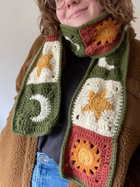 Crochet sun, moon, and star granny square scarf! This long celestial granny square scarf is completely handmade by me! Granny Square Patterns by AlyssiaCreates . All yarn used is soft acrylic in the colors pumpkin, mustard, ginger, off-white, and leaf green. The finished scarf is about 68" x 5.5" WHAT TO EXPECT - One celestial sun, moon, and star granny square scarf! - Protective packaging so the scarf doesn't get damaged during shipping. - Shipping through USPS! SHIPPING All items are handmade to order and shipped out by me, therefore it can take me 5-7 days to get an item in the mail. Once shipped all items should arrive approximately within 2 weeks, all dependent on the USPS Mailing system. DISCLAIMERS AND NOTES -All items are handmade by me at home. -The granny square patterns are by A Cool Crochet Scarves, Things Made From Granny Squares, Crochet Bird Granny Square, Crochet Cloud Granny Square, Pumpkin Crochet Square, Crochet Scarf Squares, Monstera Leaf Granny Square, Crochet Scarf Fall, Halloween Shawl Crochet Pattern