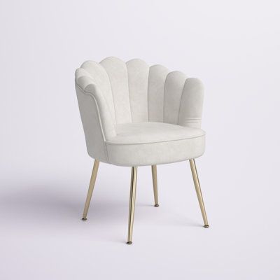 This striking barrel chair features a seashell back and glam accents for your living room or den. It has a solid and engineered wood frame, and it rests on four-angled, gold-finished metal legs. Velvet upholstery gives this armchair a luxe look, while the foam-filled seats provide plenty of support as you curl up with a good book. Vertical channel tufting along with the rounded back and recessed arms give this chair its distinctive appearance. Partial assembly is required: Just attach the legs, White Velvet Chair, Preppy Chair For Desk, Gold Accent Room Decor, Makeup Vanity Chairs, Preppy Chair For Bedroom, Comfy Vanity Chair, Makeup Vanity Chair Ideas, Cute Chairs For Desk, Preppy Chair