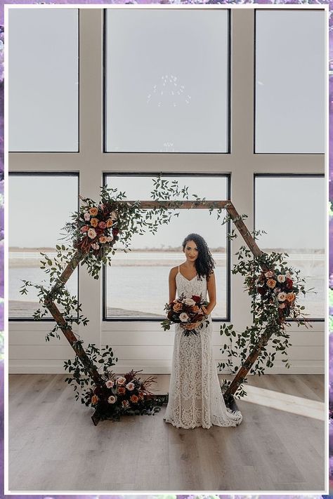 Discover stunning wedding arch ideas that will transform your ceremony into a dreamy celebration. From lush floral arrangements to elegant draping, these creative designs will enhance your special day and create the perfect backdrop for your vows. Whether you prefer a rustic charm or a modern aesthetic, our curated collection of wedding arch ideas will inspire you to craft a memorable experience that reflects your unique love story. Explore now for the perfect arch! Hexagon Wedding Arch Flowers Fall, Hexagon Wedding Arch Terracotta, Terracotta Arbor Florals, Wedding Ceremony Hexagon Arch, Terracotta Wedding Arch Decor, November Wedding Arch, Hexagon Arch Florals, Octagon Wedding Arch Decor, Octogan Wedding Arch