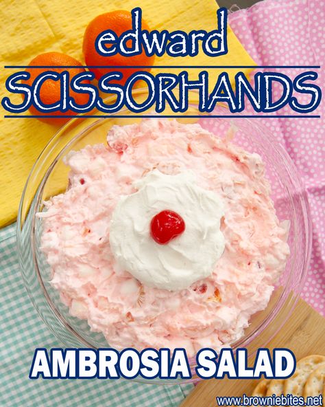 an overhead view of pink fluffy ambrosia salad topped with whipped cream and a cherry. Halloween Ambrosia Salad, Edward Scissorhands Movie Night, Pink Ambrosia Salad, Marshmallow Salad, Ambrosia Recipe, Movie Night Dinner, Frosted Lemonade, Movie Night Food, Disney Dinner