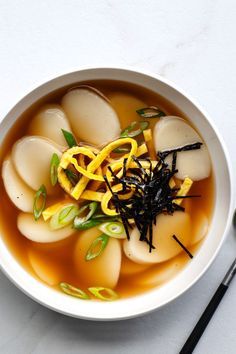 Korean New Year's Food Tradition: Rice Cake Soup (Duk Guk) Korean New Year Soup, Tteokbokki Soup Recipe, Rice Cake Soup Korean, Korean New Year Food, Duk Guk Recipe, Korean Dishes Traditional, Tteokbokki Soup, Rice Cake Recipes Korean, Korean Soups And Stews