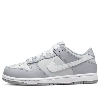 The Nike Dunk Low Two Toned Grey is a classic sportswear staple. Its iconic toebox perforations are just one part of its appeal, with eye catching details like white shoe laces and splashes of grey and blue in the tongue making it stand out even further. On top of the classic black sole, you'll find a white midsole and striking patches of grey leather on a white base. The design is complete with the famous swoosh made from white leather. If you’re looking for classic street style with an edge, $50 Shoes, Shoes To Go With Every Outfit, Grey Panda Dunks, Cute Shoes For Back To School 2024, Cute Womens Shoes Casual, Basic Nike Shoes, Back To School Shoes Dunks, Cheap Nike Dunks, Nike Shoes That Go With Everything