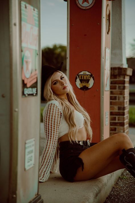 Florida based photographer photographs a western styled shoot at an old Texaco gas station in Punta Gorda, FL. Showing a model posing with playing cards and a cigarette next to the gas pumps with her in a cowboy hat, boots, and knitted long sleeve and shorts.    #westernstyledshoot #texacostyledshoot #cowgirlaesthetic #floridaphotographer #outlawphotoshoot 50s Car Photoshoot, Western Gas Station Photoshoot, Vintage Gas Station Photoshoot, Old Gas Station Photoshoot, Cowgirl Shoot, Texaco Gas Station, Gas Station Photoshoot, Couple Editorial, Western Photoshoot Ideas