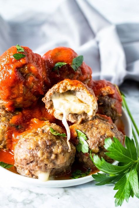 These baked meatballs are delicious and juicy, and have a surprise mozzarella center! Baked in the oven, they are the perfect accompaniment to pasta night, or just eaten as-is as an appetizer! Sometimes I will serve them alongside my vegetable tortellini casserole! The combination of beef and italian sausage makes these meatballs so flavorful and moist. The whole family gobbled them up! Extra meatballs (if there are any!) can be stored in the freezer so that you can have them on-dema… Vegetable Tortellini, Tortellini Casserole, Easy Honey Garlic Chicken, Slow Cooker Chili Easy, Homemade Burger Buns, Honey Garlic Chicken Thighs, Stuffed Meatballs, Feta Salad Recipe, Baked Meatballs