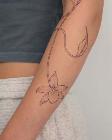 Flowy organic vine 🌿 We added orchid flowers that I shaded with dotwork to keep the delicate soft feel 🤍 I would looove to do more of these! Orchid Wrap Around Tattoo, Symmetrical Vine Tattoo, Botanical Flow Tattoo, Flowy Botanical Tattoo, Fine Line Floral Vine Tattoo, Orchid Flowers, Orchid Flower, Do More, Vines