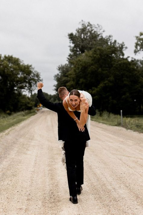 Groom walks away carrying bride over his shoulder as he celebrates with a fist in the air while bride flashes a smile and shows off her stunning wedding ring. Unique Wedding Poses, Fun Wedding Pictures, Wedding Photo List, Bride Groom Poses, Groom Photoshoot, Wedding Portrait Poses, Bride Groom Photos, Wedding Couple Photos, Unique Wedding Photos