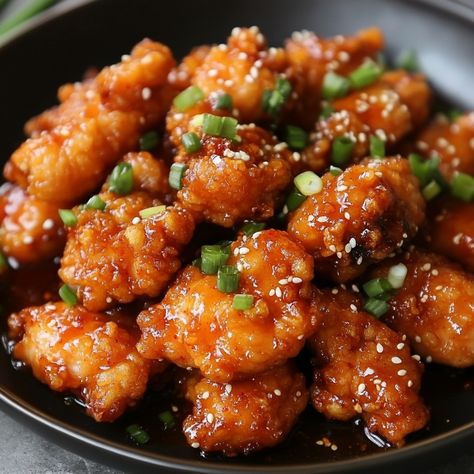 🧀🍗 Crispy, cheesy, and oh-so-sweet! Chijeu Dakgangjeong is your new go-to comfort food that everyone will love! 😍🔥 #ChijeuDakgangjeong #KoreanChicken Chijeu Dakgangjeong (Cheese Sweet Crispy Chicken) Ingredients: Chicken thighs (500g, boneless, cut into bite-sized pieces) Cornstarch (1/2 cup) Gochujang (Korean chili paste) (2 tbsp) Soy sauce (2 tbsp) Honey (3 tbsp) Garlic (3 cloves, minced) Mozzarella cheese (1 cup, shredded) Cooking oil (for frying) Green onions (2, chopped) Instructions:... Dakgangjeong Chicken, Korean Chili, Korean Chili Paste, Cozy Fall Recipes, Vegan Asian Recipes, Korean Chicken, Instagram Recipes, Homemade Sushi, Vegan Asian