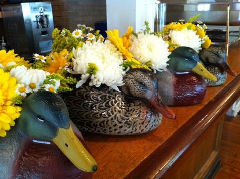 duck decoy centerpieces for a rehearsal dinner. mums, gerbera daisies, solidago, feverfew Duck Decoy Centerpiece, Nature Centerpieces, Duck Decorations, Duck Wedding, Duck Dinner, Wild Game Dinner, Party Centerpieces Diy, Dinner Centerpieces, Hunting Wedding