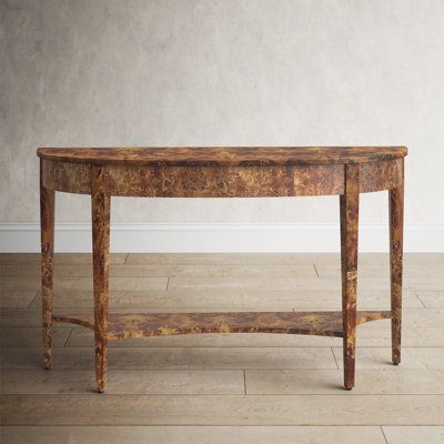 This wide console table features a stunning finish over wood. Its magnificent legs are tapered and feature carved urn medallion appliques at the top along the apron. The curvaceous lower shelf provides an intriguing counterpoint to the top. Color: Honey Burl | Birch Lane™ Angelou 54" Console Table Wood in Brown | 32 H x 54 W x 15 D in | Wayfair Burl Wood Console Table, Burl Wood Console, Wide Console Table, Natural Living Room, Coastal Living Room, French Interior, Wood Console Table, Low Shelves, Wood Console