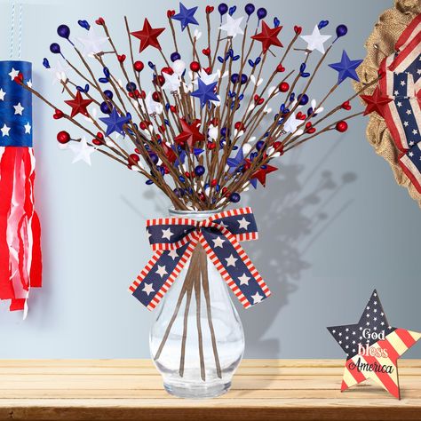 PRICES MAY VARY. Sophisticated Design：Patriotic Decorations composed of red, blue and white are light and delicate, vivid and bright, can match most styles. A unique glass bottle and flag style bowknot bringing you more decorative solutions, easily bring you the style decoration you want Elegance and Durability：High-quality 4th of July Berry Stems are Mainly made of iron pentagrams and berries made of high quality ABS material. They are firmly attached to the stems and are not easy to fall, craftsmanship, durable Versatile Usability: Artificial Berry Stem stands as a subtle yet charming 4th of July Centerpiece, can also be used as everyday home decor, they will give a different feeling to your living room, bedroom or other places Unique Patriotic Ornament: This is a unique Patriotic floral Branches Decoration, Homecoming 2024, Decoration Restaurant, 4th Of July Decor, Red Stars, Branch Decor, 4th Of July Decorations, 4th Of July Party, July Party