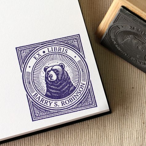 Design: Bear in Art Deco Frame Featuring a striking bear design within an Art Deco frame, this handcrafted book stamp is perfect for customizing your personal book collection, ensuring a sharp, stylish imprint every time. ♥️ HOW TO ORDER 1. Need an ink pad? - Yes (black) / No 2. Type the exact text you would like featured on your stamp, in the personalization field above.  3. Purchase Item. Done!  ♥️ STAMP DETAILS - Your stamps come with a removable handle, so you can choose to keep it on secure Stamp Letter, Ex Libris Stamp, Ex Libris Design Ideas, Art Deco Frame, Art Deco Bar, Lino Art, Book Stamp, Custom Book, Bear Design