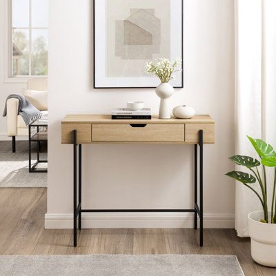 A storage-savvy piece for the modern minimalist, this one-drawer entry table will be at your beck and call for each hello and every goodbye. Keep keys, last-minute touch-up supplies, or random gadgets in the single drawer for an easy out-the-door routine. Or, keep it in your home office to display your favourite decor and conceal clutter. Wherever it is, this entry console is fit to function as a simple yet stylish statement piece, as well as a place to provide a space for any and everything. | Entry Console Table With Drawers, Mini Entry Table, Simple Entryway Decor, Key Bowl Entryway Entry Tables, Random Gadgets, Key Table, Minimalist Console Table, Small Entryway Table, Entry Console