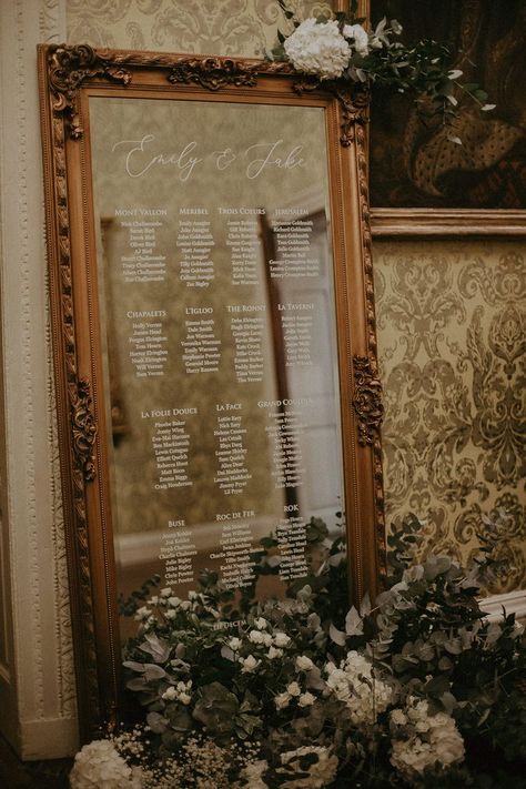 Seating chart on a mirror in white font with gold antique frame with white flowers Fall Wedding Seating, Candlelit Ceremony, Mirror Seating Chart, Hedsor House, Wedding Mirror, Wedding Table Plan, Rock My Wedding, Dirty Dancing, Style Winter