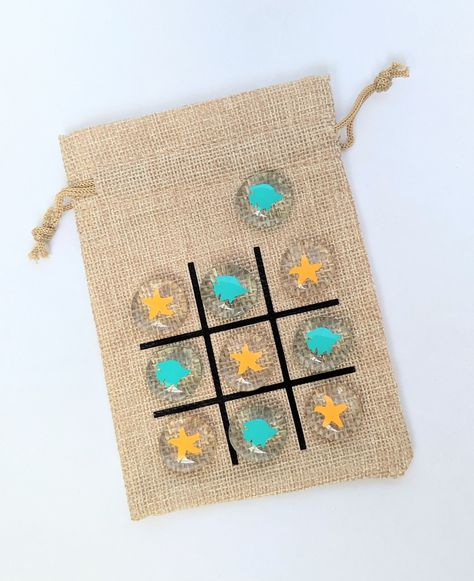 "This Tic Tac Toe game set is perfect for an Under the Sea theme or Beach party!  This set is great for a summer birthday party favor, goody bag, or class treat!   The burlap drawstring bag measures approximately 5\" x 4\" with 1\" tic tac toe board squares.  Inside the bag will be 10 glass pebbles* (5 with yellow Starfish and 5 with teal Fish). *the size and shape of each pebble is unique and may vary. Looking for a different design or quantity? Please contact us for a custom order! Checkout ou Under The Sea Birthday Party Activities, Under The Sea Birthday Party Games, Under The Sea Themed Food, Sea Theme Birthday Party, Summer Birthday Party Favors, Under The Sea Party Favors, Sea Party Favors, Sea Theme Birthday, Boys Birthday Party Games