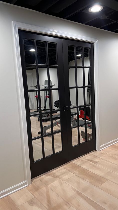 Black Door Basement, Gym French Doors, Basement Gym Doors, Black Framed French Doors, French Doors In Basement, French Doors Basement, Black Doors In Basement, Theatre Room Doors, Home Gym Doors