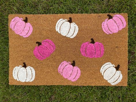 Pink Pumpkins Doormat Fall is here! Our Halloween doormat is the perfect way to spice up your front porch!  They make great gifts for housewarmings, anniversaries, birthdays, weddings, or just because! Our doormats are made of 100% natural coir and have a slip-resistant vinyl backing. All doormats are hand-painted with weather-resistant paint and sealed with a UV protectant spray. All of our doormat designs can be personalized! Want to change the color or add your name? Send us a message on Etsy or a DM us on Instagram to get started! Our Instagram account is @simplybelle.creations All doormats are hand-painted and made to order. Your order will be produced and ready to ship out in 3-5 business days. Need it sooner? Message me for rush options. Size:  18in x30in  Care Instructions: Sheddin Fall Floor Mat, Doormat Ideas Halloween, Pink And Orange Fall Decor, Diy Fall Doormat, Fall Doormat Ideas, Diy Painted Doormat, Pink Fall Decor, Home Decor Girly, Doormat Design