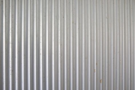 Invented in the 1820s, corrugated metal can make any house have a rustic, vintage look. Install it easily with some patient and the right tools. You'll give your house some old-fashioned personality in no time. Metal Half Wall, Corrugated Metal Door, Corrugated Metal Walls, Corrugated Fence, Laundry Designs, Sheet Metal Wall, Stove Hearth, Corrugated Wall, Hustle Lifestyle