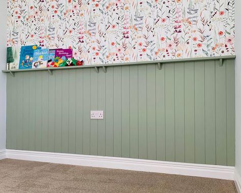 A big thank you to Ann for sharing this gorgeous photo of her nursery makeover, featuring our V-groove panelling kit and a custom picture shelf. 💚 We cut everything to the exact dimensions of her wall, making installation a breeze! The soft green paint and floral wallpaper combo is just dreamy 🌿🌸—perfect for creating a cosy and stylish space. Panelled Playroom, Green Panelling With Wallpaper, Half Wall Panelling With Shelf, Wall Half Paneling, Nursery Panelling Wall, Nursery Paneling, Panelling With Shelf, Half Paneled Walls, Half Wall Panelling