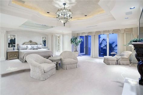 Luxury bedroom with elevated bed platform tray ceiling chandelier and balcony Bedroom With Balcony, Interior Design Contemporary, Luxe Bedroom, Luxury Beach House, Elevated Bed, Bedding Sets Online, Luxurious Bed, Luxury Bedroom Master, Beach Bedroom