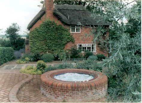 Garden Hot Tub we built to look like an old well.  Typical British Cottage Garden Garden Hot Tub, Typical British, Manor Homes, Hot Tub Patio, British Cottage, Storybook House, Old Well, Diy Hot Tub, Swimming Pool Hot Tub