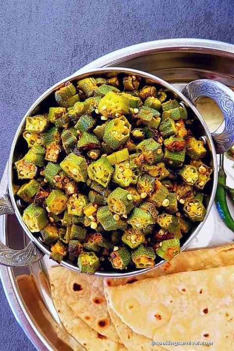 A simple, great on flavors, healthy and delicious, this Indian side dish Bhindi masala comes together in under 30 minutes. This dish is made with Okra, called bhindi in Hindi, and some basic Indian spices. This Bhindi masala is made without Tomato and garlic. Even though this bhindi recipe is made with very minimal ingredients, it never fails to wow at the dinner table. #Okrarecipe #bhindimasala #bhindi #indiansabzi #vegan #bhindifry #sidedish Stir Fry Okra, Bhindi Masala Recipe, Bhindi Fry, Bhindi Recipe, Bhindi Masala, Indian Side Dishes, Tandoori Roti, Okra Recipes, Cooking Tomatoes