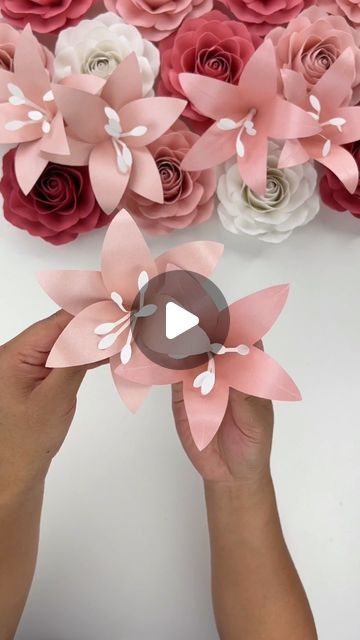 Hey, I’m Judy 👋🏻 Paper Flower Art + Tutorials on Instagram: "Here is the tutorial for my Mini Lily Template - there are two “designs” included mainly because I couldn’t pick one I liked most (and I figured anyone who wanted the template would like the two options).   The template uses very little paper per flower and I think these would be great to fill in gaps in paper flower bouquets or displays!   For paper, I used the two pink shimmer cardstock pack from @michaelsstores and I also used @bearlyarts glue for design 2. Using craft glue allows for more flexibility in the petal for shaping.   The Mini Lily Template is available in my Etsy shop, link in bio! I will also put a link in my stories and it will be saved to my “tutorial” highlights.  #paperflowers #lilies #cricut #cricutmade #te How To Make Lily Flower With Paper, Lily Flower Paper, Paper Lily Flower, Lily Template, Tiny Paper Flowers, Lilium Flower, Paper Flower Bouquets, Flower Petal Template, Paper Flower Art