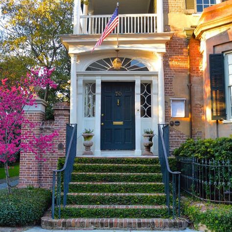 Front Door Beneath a Porch | One of our favorite aspects of the Holy City is the array of gorgeous street front doors—arguably the most charming of their kind in the South. Here, readers share Instagram snaps of beautiful Charleston doors. Share your photos with us by tagging @southernlivingmag or using #southernliving for a chance to be featured on SouthernLiving.com. Rustic Farmhouse Exterior, Double Door Entryway, Wooden Double Doors, Brown Doors, Southern Homes, Modern Farmhouse Exterior, Green Door, Splash Of Color, White Doors