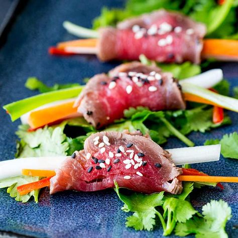 These Japanese Beef Tataki Rolls make a great canapé or hors d'oeuvre for parties. The almost raw beef is rolled around crisp vegetables making them perfect finger food. Or serve them as an appetizer at the start of a Japanese inspired meal. #rarebeef #beefappetizer #fingerfood #partyfood Asian Finger Food, Bacon Wrapped Figs, Japanese Appetizers, Pizza Twists, Beef Tataki, Beef Appetizers, Finger Food Recipes, Raw Beef, Savory Meatballs