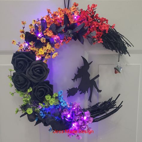 Flying Witch Moon Wreath, Halloween Wreath, Witchy Wall Decor, Gothic Door Wreath, Spooky Home Decor, Rainbow Moon Wreath, Halloween Gift This beautiful rainbow and black witch wreath is both unique and fun. The witch is attached to the wreath but appears to be flying through the moon! Perfect for Halloween lovers. Give as a gift to anyone who loves witchy decor.  Made with a grapevine base painted black. Faux floral. Witch wood cut out painted black. Purple fairy lights (on/off flat switch battery) Hanging ribbon attached. Due to the style of this wreath; it is recommended for a wall, not a door.  Thank you for visiting my shop Www.jessmadedesign.etsy.com Www.facebook.com/penguin478  Www.instagram.com/jessmadedesignetsy Crescent Moon Wreath, Witchy Wall Decor, Gothic Door, Moon Wreath, Witch Moon, Spooky Home Decor, Flying Witch, Halloween Crafts Decorations, Wreath Halloween