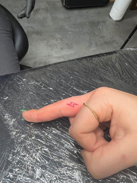 lightening bolt, Finger Lightning Tattoo, Lightening Bolt Tattoo On Finger, Lighting Bolt Tattoo Behind Ear, Lighting Bolt Tattoo Red Ink, Lightning Finger Tattoo, Red Lightning Bolt Tattoo, Red Lightening Tattoo, Fine Line Lightning Bolt Tattoo, Pink Line Tattoo