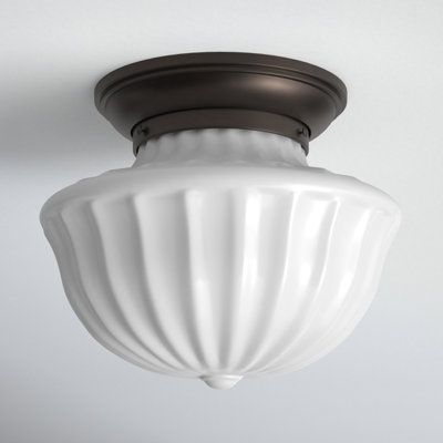 In the early 1920s, exposed-bulb light fixtures were jettisoned in favor of opaque glass globes that disguised the light source. These pieces found popularity predominantly in schoolhouses, giving this style its name. Here, we start with a classic schoolhouse glass shape and take it up a notch with lovely fluting that beautifully diffuses the light. The uncomplicated metal work and the iconic glass shape call to mind a time when the world seemed a simpler place. Size: 7.5" H x 9" W, Finish: Old Light Fixture For Hallway, Milk Glass Ceiling Light, Vintage Flush Mount Lighting, Hallway Flush Mount Lighting, Bauhaus Lighting, Exposed Bulb Lighting, Hallway Pendant Lighting, Retro Lights, Schoolhouse Style