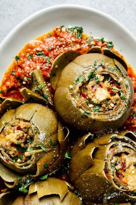 Packed with lean protein, Italian herbs, and seasoning and ready when you are, these Slow Cooker Stuffed Artichokes are a satisfying twist on the traditional breadcrumb and cheese stuffed artichokes that are so rightfully popular in Italian cooking. Italian Stuffed Artichokes, Stuffed Artichokes, Slow Cooker Italian, Chicken With Italian Seasoning, Course Ideas, Italian Herbs, Artichoke Recipes, Gluten Free Egg Free, Homemade Marinara