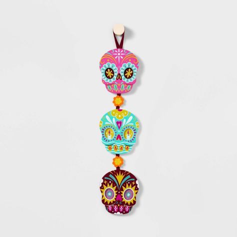 Highlights Day Of The Dead Decorative Sign Colorful Design By Luis Pinto 3-Tier Linear Wall Hanging With Festive Calaveras Wood Construction Top Loop For Easy Display Forest Stewardship Council Certified Description Amp Up Any Bare Wall With Festive, Seasonal Vibes With This Da De Muertos Trio Calavera Wooden Sign Designed With Luis Pinto. Featuring A Traditional Design, This 18-Inch Wall Hanging Is Made Of Three Wood-Composite Sugar Skulls In Bright Pink, Light Aqua Green And Burgundy Colors Th Dia De Los Muertos Decorations Ideas, Burgundy Ribbon, Skull Wreath, Green And Burgundy, Cookies For Santa Plate, Target Gifts, Wood Composite, Felt Halloween, Día De Muertos