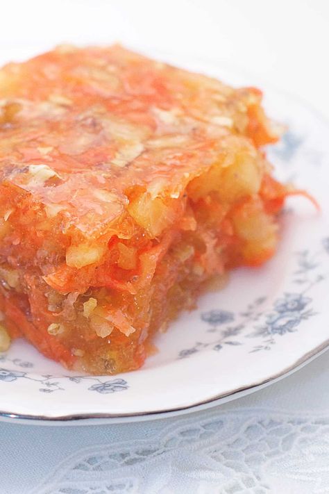 Sunshine Salad is a traditional gelatin salad, or congealed salad, made with lemon jello, pineapple, carrots, and chopped nuts. From @NevrEnoughThyme https://www.lanascooking.com/sunshine-salad/ Orange Jello With Carrots And Pineapple, Salads With Crushed Pineapple, Perfection Salad Jello, Sunshine Jello Salad Recipe, Carrot Pineapple Jello Salad, Congealed Fruit Salad Recipes, Retro Jello Salad Recipes, Easter Congealed Salad, Old Fashion Jello Salads