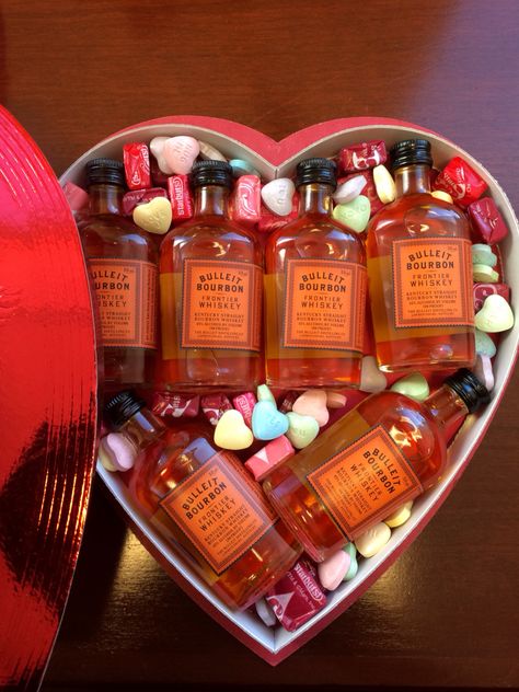 Valentine's Day present for your whiskey loving guy!   Best Valentines Day gift I will ever give! May have to make this an annual gift.    - As many Mini Bulleit Bourbon Whiskey bottles as you can fit - 1 heart shaped box (no one likes those mystery chocolates anyway!) - Starburst Fav Reds - SweetTarts candy hearts  Put it together, tap it shut, and wait for his face when he opens it expecting chocolate. Whiskey Valentines Gift For Him, Sweet Tarts Candy, Liquor Bouquet, Valentines Brunch, Whiskey Bottles, Bulleit Bourbon, Wine Baskets, Valentine Desserts, Whiskey Gifts