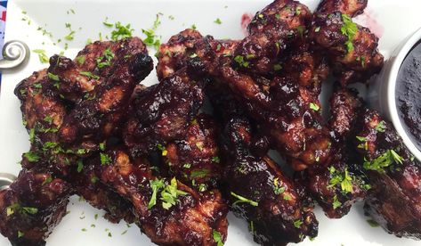 These blueberry chicken wings are the perfect blend of sweet and savory flavors with the use of sweet and tangy blueberries and hot chipotle. Step up your next backyard barbecue or summertime party with this easy-to-make, but hard-to-keep recipe. Whether you serve it as an appetizer or main course, these wings are sure to be a major hit. Chipotle Wings, Chipotle Chicken Marinade, Blueberry Chicken, Wings Food, Barbecue Chicken Wings, Grilled Wings, Spicy Wings, Bbq Wings, Chipotle Chicken