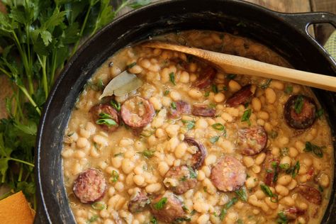 A local and regional dish that’s almost as beloved as New Orleans Red Beans & Rice, it's typically made with navy beans, the trinity, and either smoked or andouille sausage. White Beans And Rice, Camellia White, White Bean Recipes, Recipes Southern, Southern Louisiana, Beans And Sausage, Louisiana Style, Southern Mom, Northern Beans