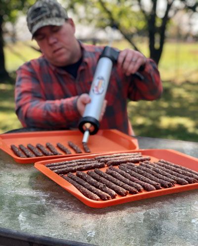 Pellet Smoker Venison Jerky | Mossy Oak Venison Jerky Smoker, Smoked Ground Venison Jerky Recipe, Deer Jerky Recipe Smoker, Traeger Jerky, Smoked Deer Jerky, Smoker Jerky Recipes, Venison Snack Stick Recipe, Deer Burger Recipes, Venison Snack Sticks