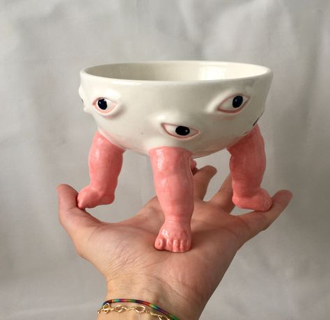 The painstaking made ceramic baby footed bowl is completely handmade. *  It is a completely original piece with its plain eyes and stance. * With this clay art bowl, you can add a different atmosphere to your home, kitchen and office or living space. You can surprise your partner or best friend with this personalized gift. * It is compatible with health and food. It can be thrown into the dishwasher. It is glazed. It is environmentally friendly. Diameter: ~ 14.5 cm, Height: 12 cm Custom Pottery, Funky Home, Orange Ceramic, Creation Art, Art Bowls, Weird Gifts, Funky Home Decor, Keramik Design, Footed Bowl