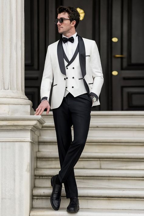 Step into matrimonial bliss with our White Slim-Fit Tuxedo 3-Piece, a symbol of refined elegance and unmatched style. Crafted for the groom who appreciates sophistication, its crisp white hue and slim-fit silhouette promise to elevate your wedding day ensemble to new heights of sophistication and charm.  #whitetuxedo #tuxedo #singlebreasted #suit #suits #slimfit #menstyle #menfashion #fashioninspo #formalwear #menclothing #formalattire Bow Tie Suit, Modern Fit Suit, Suit Stores, Black Suit Men, Slim Fit Suit Men, Suit Styles, Slim Fit Tuxedo, White Tuxedo, Tuxedo Blazer