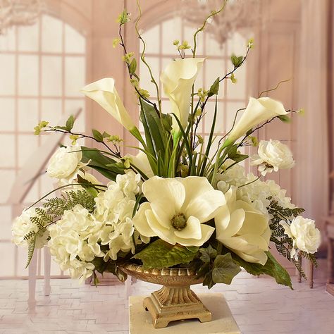 Cream Magnolia and Hydrangeas with Calla Lillies AR413 .Elegantly styled silk flower centerpeice arranged with soft cream hydrangeas, magnolias, and calla lillies. Accented with wispy branches, ranunculus and fern. This beautiful silk arrangement is displayed in a champagne pedestal vase. Measures 24"H x 23"W x 16"D Silk Floral Centerpiece, Orchid Centerpiece, Gold Pedestal, Silk Flower Centerpieces, Orchid Centerpieces, Large Floral Arrangements, Hydrangea Centerpiece, Large Flower Arrangements, Gubahan Bunga